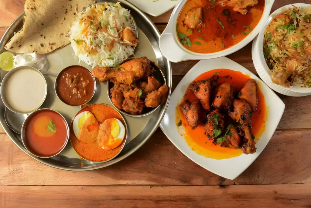 Assorted indian foods pepper chicken gravy,chicken masala and nonveg thali on wooden background. Dishes and appetizers of indian cuisine