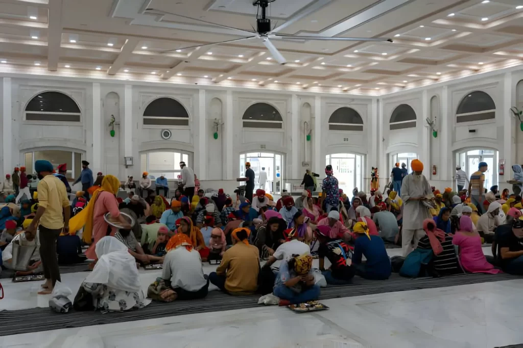 People eating in the food hall of Gurudwara Bangla Sahib, a famous Sikh house of worship.