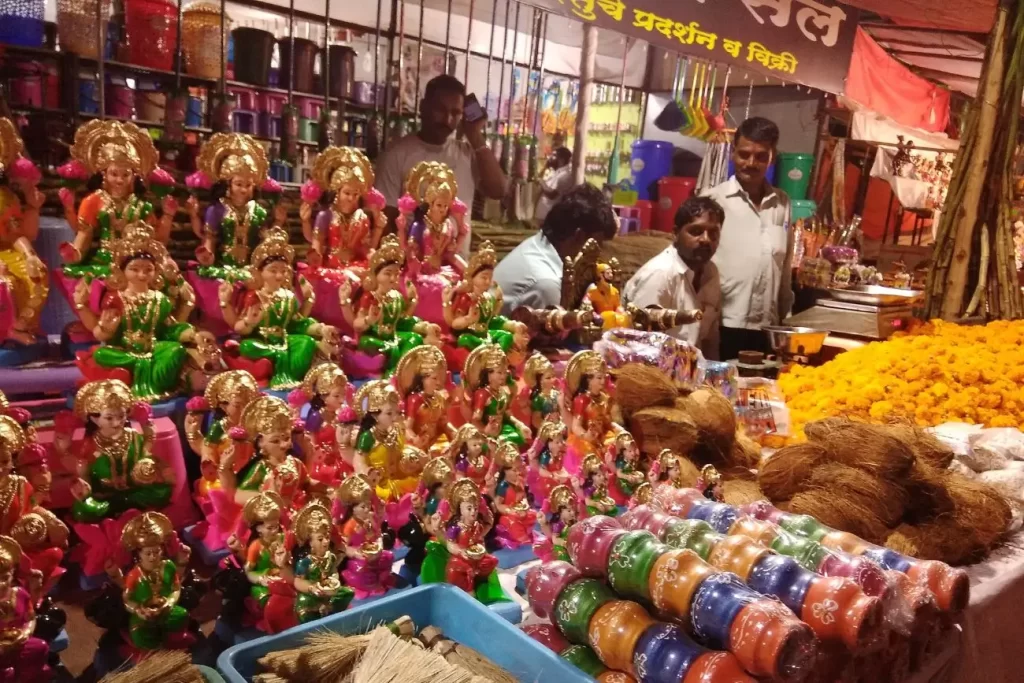 Street shop selling shree laxmi statue flowers and other worship items on diwali