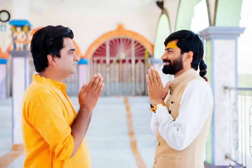 Temple Visitor and Hindu Priest Greeting Each Other