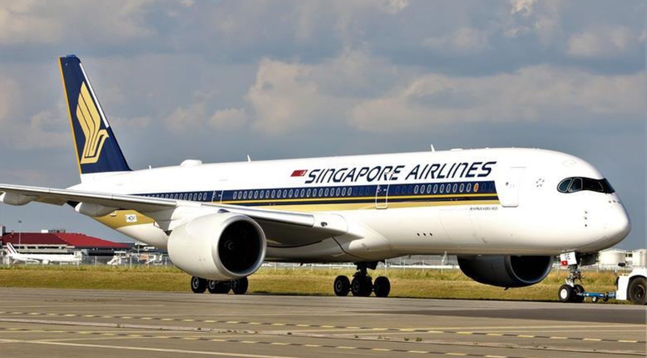 Singapore Airlines Airbus A350-900 taxiing on a runway under a partly cloudy sky, symbolizing a flight route connecting the USA and India.