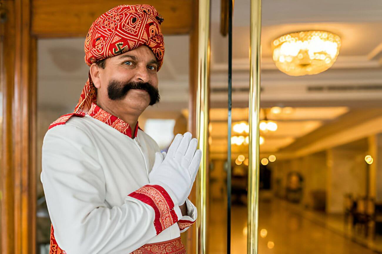 Indian Concierge Welcome Guest at Hotel Entrance Showing The Royal Hospitality Of India