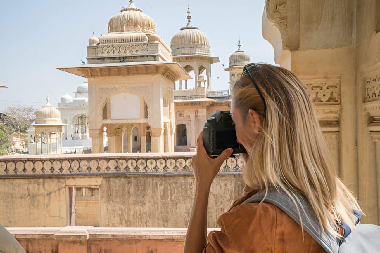 Tourist photographing ancient temple using camera, Jaipur, Rajasthan