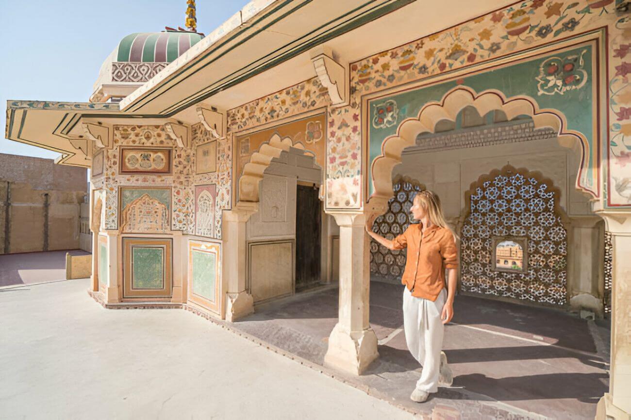 young-woman-traveling-in-india-contemplating-ancient-temple-in-jaipur-india