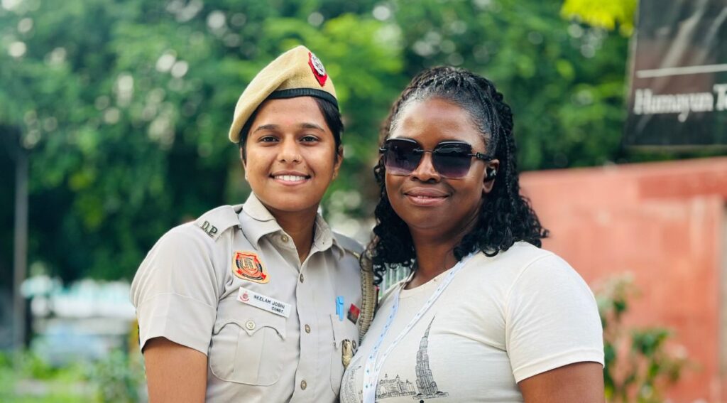 "Tourist posing with Delhi Police officer during Golden Triangle tour."






