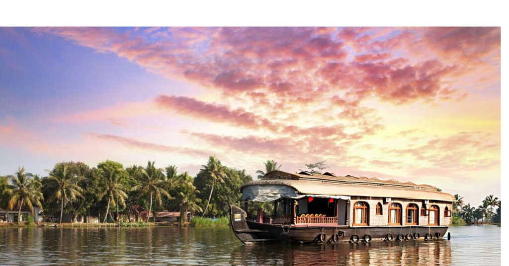 Traditional houseboat on Kerala's serene backwaters with a picturesque sunset sky in the background.