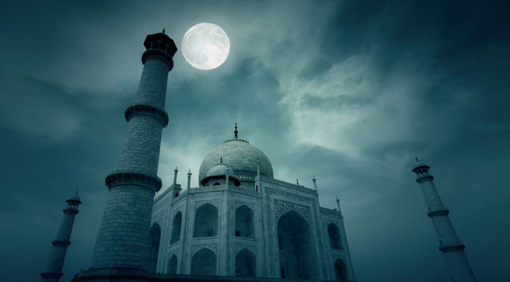 The Taj Mahal illuminated by the soft glow of a full moon, its white marble shimmering against the dark night sky with a serene reflection in the Yamuna River."